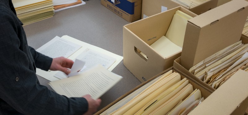 Someone filing papers away in boxes