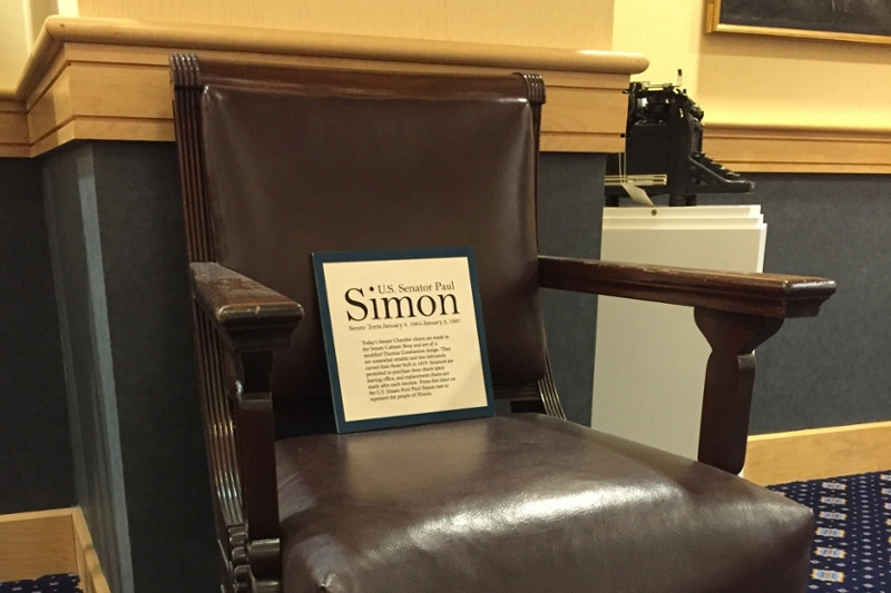 Brown Leather Chair With a Frame that says "Senator Paul Simon"